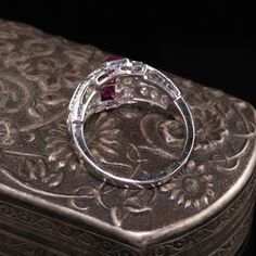 Gorgeous Antique Art Deco Platinum Diamond and French Cut Ruby Ring. A beautiful Art Deco ring finely made and features 4 large French cut rubies going down the center. The ring is also numbered. Item #R0762 Metal: Platinum Diamonds: Approximately 1 cts Ruby: Approximately .80 cts French Cut Weight: 5.1 Grams Size: 5 1/4 Measurements: 12.1 mm long and 5 mm off the finger. Layaway: For your convenience, we will be happy to provide layaway payment options. Please contact us to work out a layaway p Luxury Ruby Ring With Diamond Accents And Round Shape, Luxury Round Ruby Ring With Diamond Accents, Luxury Ruby Rings With Diamond Accents, Luxury Ruby Rings With Prong Setting, Luxury Ruby Promise Ring With Prong Setting, Luxury Ruby Ring With Prong Setting For Promise, Exquisite Ruby Rings With Diamond Accents, Luxury Ruby Round Cut Rings, Luxury Round Cut Ruby Promise Ring