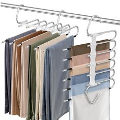 clothes hangers are hanging on the wall and folded in different colors, shapes and sizes