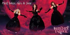 three women in black dresses with their arms spread out, and the moon behind them