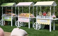 an assortment of food stands on grass with pink and yellow decorations in the back ground