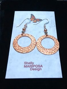 Lightweight Hammered copper hoop dangle earrings. Looking for something lightweight, bright and natural? This simple yet elegant pair of hammered copper earrings will definitely catch the light! These earrings are solid high-quality copper. One side is hammered, the other side of smooth. These earrings are 1 inch in diameter. They are very light weight, only 2 g. French ear wires are also solid copper. All my jewelry comes gift boxed with a custom Shelly Mariposa Design butterfly card ready for Handmade Copper Round Hoop Earrings, Hammered Copper Hoop Jewelry, Small Copper Hoop Jewelry, Hammered, Handmade Copper Hoop Earrings, Handmade Small Hoop Copper Earrings, Copper Dangle Hoop Earrings Gift, Handmade Small Copper Hoop Earrings, Hand Forged Copper Hoop Earrings With Dangle, Hand Forged Copper Dangle Hoop Earrings