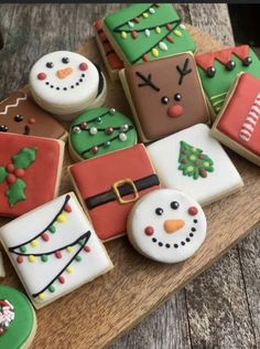 decorated christmas cookies sitting on top of a wooden table