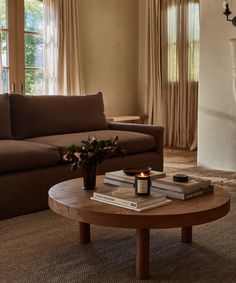 a living room with two couches and a coffee table in front of a fireplace