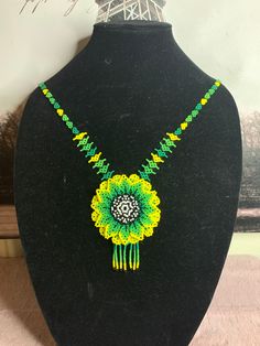 All our pieces are genuine and each chaquira is handcrafted by artisans from the most representative areas of huichol art. Unique Hand-strung Yellow Necklace, Round Beaded Macrame Necklace As A Gift, Unique Yellow Hand-strung Necklace, Artisan Green Hand-strung Necklace, Adjustable Green Handwoven Necklace, Adjustable Handwoven Green Necklace, Handmade Yellow Beads, Yellow Artisan Beads As A Gift, Unique Handmade Yellow Beads