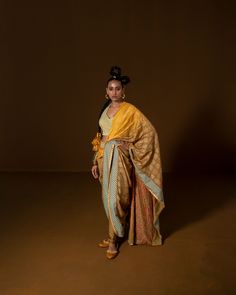 CHAKRA PHOOL SARI YELLOW : this summer silk sari is pre-draped , with hand embroidery along the borders and pallu . The blouse is corsetted and fully hand embroidered using intricate sequin. Fabric : summer silk + lycra olive mustard Color 15 DAYS Delivery DRYCLEN ONLY DRYCLEN ONLY, STORE IN PLASTIC GARMENT BAGS FOR THE PRINT TO RETAIN SHINE 3 Components Garment Bags, Borders, Chakra, Hand Embroidered, Hand Embroidery, Custom Print, Yellow, Fabric, Color