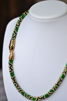 "Green gold snake serpent necklace beaded python animal long lariat transformer neckpiece hippie jewelry Length: 16 inches (40 cm) 18 inches (45 cm) 20 inches (50 cm) 25 inches (63 cm) 30 inches (75 cm) 35 inches (88 cm) 40 inches (100 cm) Matching earrings https://www.etsy.com/listing/473229526 ❤ CUSTOM ORDERS It is ABSOLUTELY HANDMADE . So if you like this item in a different color or size, send me a message please. I will send you a link for a \"custom order\" and you'll be able to place the Spiritual Long Green Necklace, Bohemian Adjustable Snake Jewelry, Adjustable Bohemian Snake Jewelry, Handmade Bohemian Snake Jewelry, Handmade Bohemian Snake Necklace, Handmade Snake-shaped Beaded Necklace For Gift, Handmade Bohemian Snake-shaped Jewelry, Spiritual Snake-shaped Necklace For Gifts, Unique Green Snake-shaped Jewelry