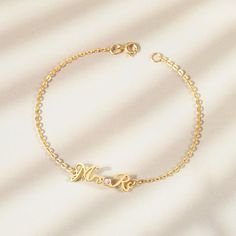 a gold bracelet with the word love on it