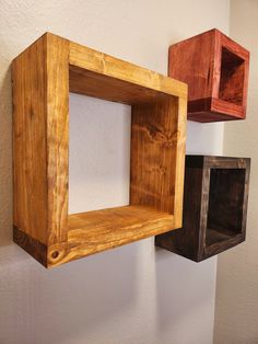 three wooden boxes are hanging on the wall