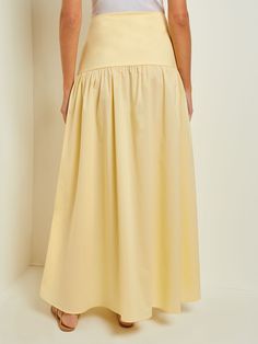 Discover the quality craftsmanship and comfort of Misook's Maxi High-Low Skirt - Flounce Cotton in Pale Gold. All of our designer knitwear and wovens come with complimentary shipping and returns. Asymmetrical Skirt With Pleated Hem For Spring, Asymmetrical Skirt With Pleated Hem For Summer, Summer Asymmetrical Skirt With Pleated Hem, Cotton Tiered Skirt In Solid Color, Cotton Tiered Skirt With Solid Color, Solid Maxi Skirt For Daywear, Spring Maxi Skirt With Gathered Detail, Solid Flared Skirt For Daywear, Solid Color Voluminous Skirt For Summer