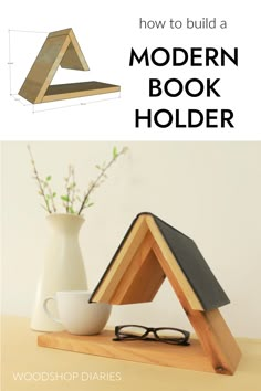 a wooden book holder sitting on top of a table next to a vase with flowers