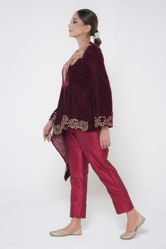 Maroon full sleeves cross cut tunic crafted in velvet with kashmiri bloom golden tilla embroidery detail. Paired with a straight silk pant. - Aza Fashions Resham Embroidered Kaftan For Reception, Long Sleeve Kaftan With Resham Embroidery For Reception, Eid Velvet Fitted Bandhgala, Fitted Velvet Bandhgala For Eid, Wedding Velvet Long Sleeve Bandhgala, Long Sleeve Kaftan With Dabka Work For Reception, Velvet Bandhgala For Eid Festivities, Velvet Long Sleeve Kurta For Party, Velvet Long Sleeve Party Kurta