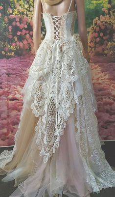 a mannequin wearing a dress made out of white lace