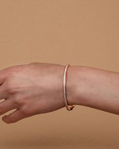 Our Lana Bangle is an essential piece of arm candy that you absolutely need in your jewelry box. Sleek and minimal with the subtle glimmer of the cubic zirconia, this bracelet can accompany you to any event or occasion.Materials 14K yellow gold, rose gold or white gold plated AAAAA Cubic Zirconia Measurements: Width: 64.5mm (2.54”); Height: 57.5mm (2.26”); Thickness: 3.3mm (.13”) Hypoallergenic; nickel, lead, and cadmium free Minimalist Gold Cubic Zirconia Bangle Bracelet, Everyday Luxury Rose Gold Cubic Zirconia Tennis Bracelet, Rose Gold Cubic Zirconia Gold Bracelet As Fine Jewelry, Modern Rose Gold Tennis Bracelet As A Gift, Rose Gold Tennis Bracelet For Everyday, Modern Rose Gold Tennis Bracelet As Gift, Everyday Rose Gold Round Tennis Bracelet, Modern Rose Gold Tennis Bracelet For Gift, Dainty Rose Gold Diamond Bangle Bracelet