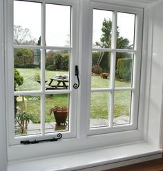 an open window with the view of a yard and picnic table in the back ground