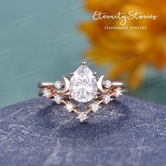 a close up view of a diamond ring on top of a rock with sunflowers in the background