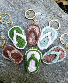 crocheted flip flop keychains are laying on a rock