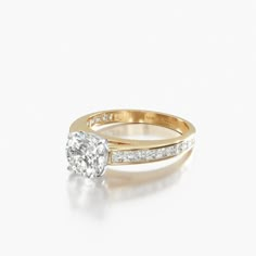 a yellow gold engagement ring with diamonds on the band and an oval cut diamond in the center