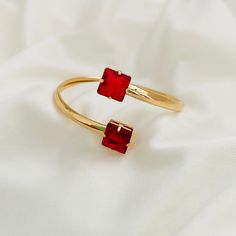 Are you looking for the perfect complement to your jewelry collection? Our Red Cuff Bracelet has the July stone, the Ruby, special to make a unique gift for the birthday girls of that month and for people who love this color. Our Ruby Bangle Bracelet is just what you need. Its beautiful red stones will make you shine and dazzle in front of everyone, ideal for any occasion. If you like it, click on the cart, and we will prepare it for you!  Product: - Ruby Bracelet -Material: 18K Gold Filled -Ban Red Ruby Bracelets As Gift, Red Metal Bracelets As Gift, Adjustable Ruby Jewelry For Gifts, Red Jubilee Bracelet Jewelry Gift, Red Bangle For Jewelry Making, Ruby Bracelets With Jubilee Style As A Gift, Red Gemstone Bracelets As Gift, Ruby Bracelets With Jubilee Bracelet As Gift, Ruby Jubilee Bracelet As A Gift