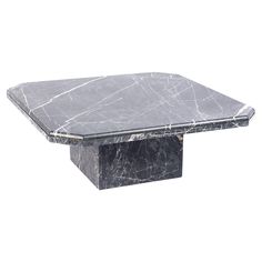 a black and white marble coffee table with a square shaped design on the top, in front of a white background