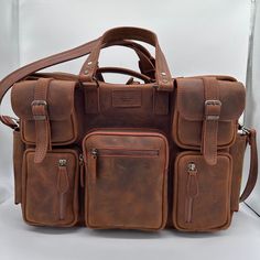 This leather travel bag is perfect for the modern traveler. It's made from high-quality leather that will only get better with age, and it has a spacious interior that can fit everything you need for a weekend getaway or a longer trip. The bag also features a number of pockets and compartments to keep your belongings organized, and it comes with a detachable shoulder strap for comfortable carrying. Features: Made from high-quality leather Spacious interior Multiple pockets and compartments Detac Classic Satchel For Travel Shaped As Backpack, Classic Travel Satchel Shaped As Backpack, Luxury Rectangular Leather Backpack For Trips, Functional Satchel Leather Backpack For Travel, Luxury Leather Rectangular Backpack For Trips, Functional Leather Satchel Backpack For Travel, Luxury Leather Backpack For Trips, Classic Travel Satchel Backpack, Large Capacity Leather Shoulder Briefcase