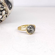 Dainty adjustable rings raw Iron Pyrite  in KC Gold, yellow gold or Silver colour metal rings, one size N 6+ metal: stainless steel  Handmade in Greece, with love 💕 and carefully manufactured. Thank you for visiting my shop. May you also like: All Pyrite jewelry in my shop here: https://www.etsy.com/shop/DinasCraftsGalerie?ref=seller-platform-mcnav&search_query=Pyrite CRYSTAL NECKLACES: https://www.etsy.com/shop/DinasCraftsGalerie?ref=seller-platform-mcnav§ion_id=34688097 MACRAME BRACELETS: https://www.etsy.com/shop/DinasCraftsGalerie?ref=seller-platform-mcnav§ion_id=35441023 BACK TO SHOP:  https://www.etsy.com/shop/DinasCraftsGalerie?ref=seller-platform-mcnav Gold Midi Rings With Gemstone Round Shape, Gold Midi Rings With Gemstone, Adjustable Gold Gemstone Rings, Adjustable Gold Gemstone Jewelry, Nickel Free Gold Spiritual Rings, Nickel-free Gold Spiritual Rings, Gold Spiritual Nickel-free Rings, Adjustable Round Stone Rings For Gifts, Adjustable Round Stone Ring For Gift