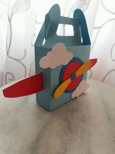 a paper bag with a plane and clouds on it