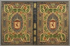 an old book with decorative designs on the cover and side panels, both decorated in gold and blue