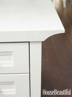 a close up of a white table with drawers