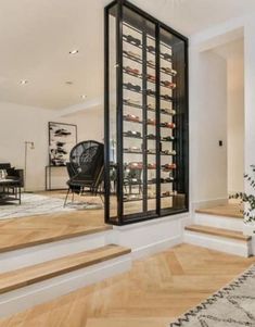 there is a wine rack on the wall in this living room with hardwood flooring