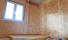 the inside of a house being built with plywood boards and insulation on the walls