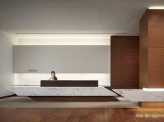 a woman is sitting at the reception desk