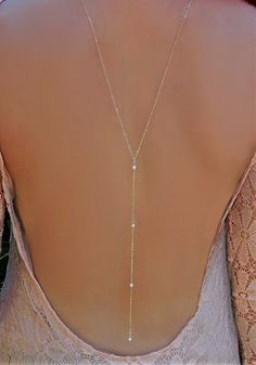 Cubic Zirconia Lariat Y Back Necklace This very elegant Lariat Back Necklace is perfect for that special occasion. This has a delicate a round CZ in the front. Gorgeous! Materials: ✦ Sterling Silver or Gold Filled Chain ✦ Shown at 26 with an 8 drop (No Clasp) ✦ 2 - Silver or Gold  Measure with dress on to ensure low back is correct size Luxury Yellow Gold Backdrop Necklace For Women, Luxury Yellow Gold Backdrop Necklace As A Gift, Silver Cubic Zirconia Lariat Necklace For Wedding, Silver Crystal Lariat Necklace For Wedding, Silver Lariat Necklace With Pearl Chain For Wedding, Dainty Drop Backdrop Necklace For Wedding, Jóias Body Chains, Pearl Backdrop, Backdrop Necklace