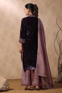 Purple velvet kurta with floral embroidery. Comes with hand embroidered hem pant and dupatta.
Components: 3
Pattern: Hand Embroidered
Type Of Work: Sequins, Pearls, Cutdana
Neckline: V Neck
Sleeve Type: Three Quarter
Fabric: Kurta: Velvet, Pant: Chanderi, Dupatta: Organza
Color: Purple
Other Details: 
Attached lining
Approximate product weight: 0.5-1 kg
Occasion: Wedding - Aza Fashions Traditional Formal Pant Set With Resham Embroidery, Formal Eid Sharara With Floral Embroidery, Formal Floral Embroidered Sharara For Eid, Formal Unstitched Sharara With Floral Embroidery, Traditional Embroidered Formal Pant Set, Festive Pant Set With Embroidered Border For Diwali, Formal Diwali Sets With Embroidered Border, Formal Sets With Embroidered Border For Diwali, Fitted Sets With Embroidered Border For Festive Occasion