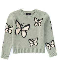 a green sweater with butterflies on it