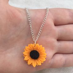 Silver plated chain necklace with orange sunflower charm You can pick your necklace length from: 16 inches 18 inches 20 inches 22 inches 24 inches Comes in an organza bag 💫💫 Summer Orange Flower-shaped Jewelry, Summer Flower Charm Necklace As A Gift, Summer Flower Charm Necklace For Gift, Summer Flower Charm Necklace As Gift, Summer Gift Necklace With Flower Charm, Summer Flower Pendant Necklace Gift, Orange Necklace With Adjustable Chain For Gift, Orange Necklace With Adjustable Chain As Gift, Yellow Round Sunflower Jewelry