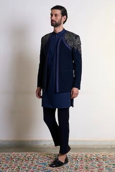 Navy blue bandhgala with placement hand embroidery, accentuated with golden stud work. Paired with an inner kurta and straight pant. - Aza Fashions Ceremonial Blue Bandhgala With Dabka Work, Fitted Blue Bandhgala With Dabka Work, Fitted Bandhgala For Navratri Festive Occasions, Fitted Bandhgala For Navratri Festivities, Festive Fitted Bandhgala For Navratri, Fitted Bandhgala With Dabka Work For Navratri, Fitted Traditional Bandhgala For Navratri, Fitted Bandhgala For Ceremonial Occasions During Navratri, Fitted Bandhgala With Dupatta For Diwali