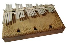 an old wooden musical instrument with white strings