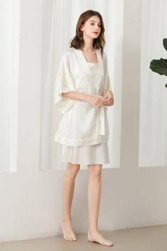 Fabric: 92% 19 Momme mulberry silk 8% Spandex Color: White Care: Hand wash or dry clean Silk robe dressing gown. Dolman sleeves. Shawl collar. Dropped shoulders. Open front. Fastens with a matching belt. Closing edge. Unlined. This wrap is designed with kimono proportions, but with a more modern short length. Elegant V-neck Loungewear Sets, Silk V-neck Kimono For Daywear, Silk V-neck Robe For Loungewear, Satin V-neck Robe For Daywear, Spring V-neck Night Robe, Satin V-neck Robe For Loungewear, Elegant Spring Sleepwear, Elegant Spring Sleepwear For Night, Elegant Open Front Night Dresses