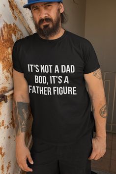 Upgrade your dad's style with our "It's Not a Dad Bod, It's a Father Figure" T-shirt. This soft, comfortable tee combines humor and pride, perfect for the dad who embraces his role with confidence and a smile. Ideal for Father's Day, birthdays, or any day he wants to make a statement. This unisex ultra cotton tee is a classic. The shoulders are tapped for a good upper-body fit. There are no side seams, ensuring a clean, unbroken flow. The collar has ribbed knitting for improved elasticity. The m Father's Day T-shirt With Funny Text In Relaxed Fit, Black Relaxed Fit T-shirt With Quote Print, Summer Black T-shirt With Quote Print, Black Slogan Top For Father's Day, Funny Quote Print Black Tops, Casual Black Top For Father's Day, Funny Crew Neck Top For Father's Day, Father's Day Crew Neck Top With Funny Print, Father's Day Funny Print Crew Neck Top