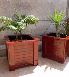 two wooden planters sitting next to each other