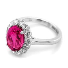 Immerse yourself in the beauty of this exquisite ring featuring a vivid pink sapphire from Madagascar, elegantly set in 18K white gold. Enhanced by sparkling diamonds, this piece is a perfect blend of luxury and timeless elegance.  Ring Overview: Center Stone: 5.34 carats of natural purplish pink sapphire, renowned for its vivid and captivating hue. Shape: Oval, offering a classic and elegant silhouette. Dimensions: 11.13 x 8.30 x 6.68 mm, highlighting the sapphire's impressive size and brillian Luxury Pink Ruby Ring In Platinum, Pink Diamond Ring With Halo Setting For Formal Occasions, Pink Diamond Ring With Halo Setting For Formal Events, Formal Pink Diamond Ring In Platinum, Pink Platinum Ruby Ring, Pink Sapphire Ring With Halo Setting For Formal Occasions, Elegant Pink Diamond Ring In Platinum, Luxury Pink Ruby Ring With Halo Setting, Formal Pink Sapphire Diamond Ring With Halo Setting