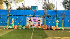 an outdoor basketball court decorated with balloons and decorations