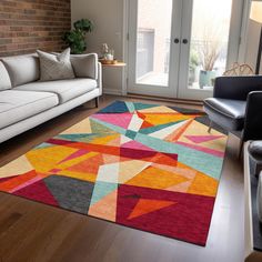 a living room filled with furniture and a colorful rug