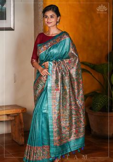 Madhubani - the ancient folk art that is characterized by its unique rigid designs filled by lines and colorful pigments. This saree is handpainted by artists in detail over the pallu and borders over light and earthly tussar fabric. The base color is teal that contrasts the work well! This saree comes with an unstitched blouse fabric and is ready to wear with fall and pico complete. Handmade tassels line the pallu. SILK MARK CERTIFIED This saree is ready to wear with fall and pico done. Handmade silk tassels adorn the pallu and add more grace to it. An unstitched blouse fabric is included. *Note: There may be minor variations in the shade, the texture of the product. Hues/textures show differently due to variations in screen settings and other factors, *Note: This is a handwoven saree and Bohemian Tussar Silk Traditional Wear For Navratri, Bohemian Tussar Silk Saree For Festivals, Bohemian Tussar Silk Saree For Eid, Traditional Tussar Silk Wear With Kalamkari Print, Traditional Chanderi Kalamkari Print Wear, Meenakari Tussar Silk Traditional Wear For Navratri, Tussar Silk Traditional Wear With Meenakari For Navratri, Bohemian Traditional Wear In Raw Silk For Navratri, Bohemian Saree With Cutdana For Rituals