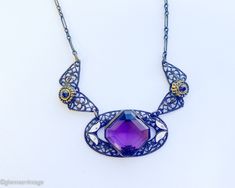 "~ 1920s gorgeous old brass filigree necklace with purple glass ~ Large faceted purple glass stone ~Old wonderful chain, paper clip style ~ Delicate enamel leaves ~ Excellent condition Length- 18\" (45.5 cm) Drop when held- 8.5\" (21.59 cm) More Fantastic Vintage Jewelry: glennasvintageshop.etsy.com Additional Vintage in our sister shop Glenna's Jewels: glennasjewels.etsy.com Instagram @glennas_clothing Facebook https://www.facebook.com/glennasclothing" Antique Purple Metal Jewelry, Purple Art Deco Necklace For Gift, Antique Handmade Purple Jewelry, Purple Filigree Pendant Necklace, Handmade Antique Purple Jewelry, Purple Pendant Necklace With Filigree, Antique Purple Jewelry With Intricate Design, Vintage Purple Jewelry With Intricate Design, Purple Vintage Jewelry With Intricate Design