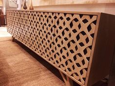 a wooden bench sitting on top of a carpeted floor