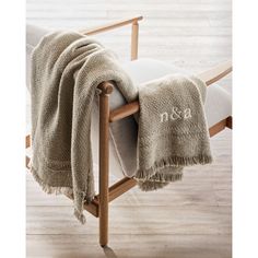 a chair with a blanket on top of it and a wooden frame around the back