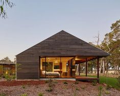 a small wooden house sitting on top of a lush green field