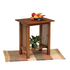 a small wooden table with fruit and vegetables on top, sitting on a rug in front of a white background