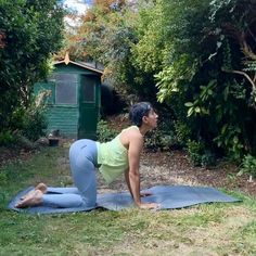 a woman is doing yoga outside in the grass